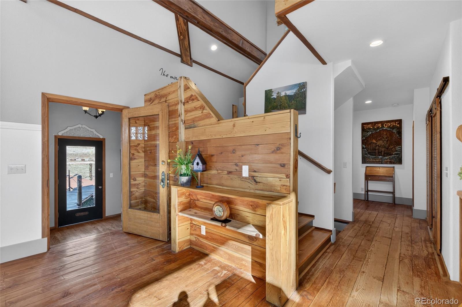 31885 Ridge Road Ramah, CO 80832 - Photo 24 of 47 a view of a hallway with wooden floor and a living room