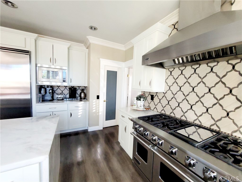 14119 Ashton Lane Riverside, CA 92508 - Photo 26 of 47 a kitchen with a stove and white cabinets