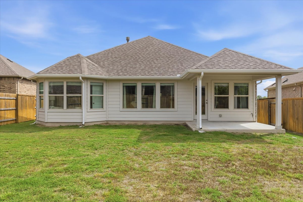 366 Cold Riv Run Kyle, TX 78640 - Photo 23 of 31 Expansive backyard featuring a covered patio, a bay window extension, and a wood privacy fence