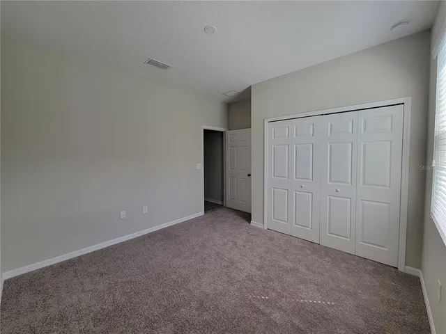 a view of an empty room and closet area
