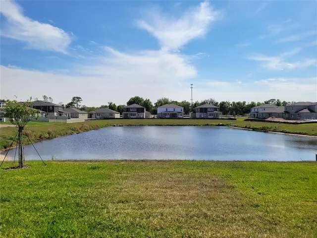 a view of a lake with houses in the background