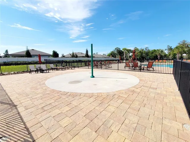 a swimming pool with outdoor seating and plants