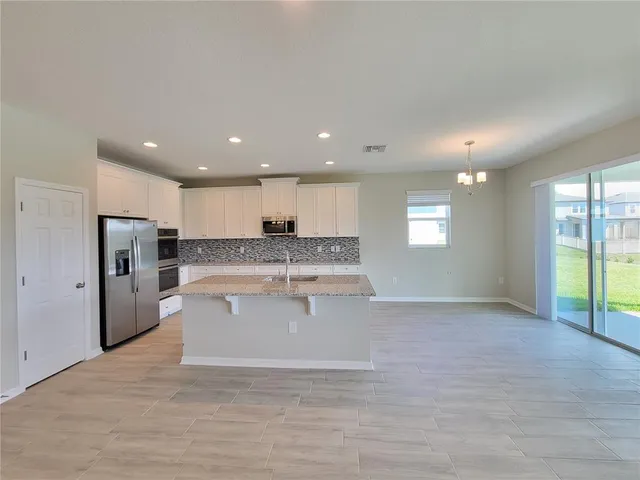 a view of kitchen with refrigerator and window