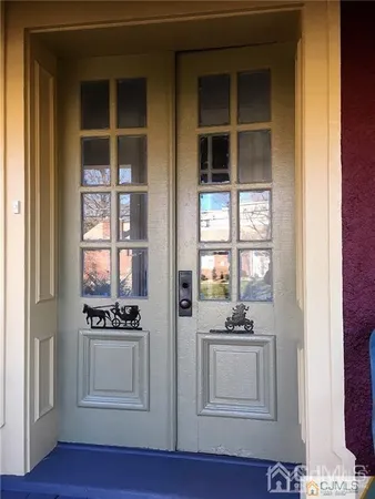 a view of kitchen with white cabinets and window