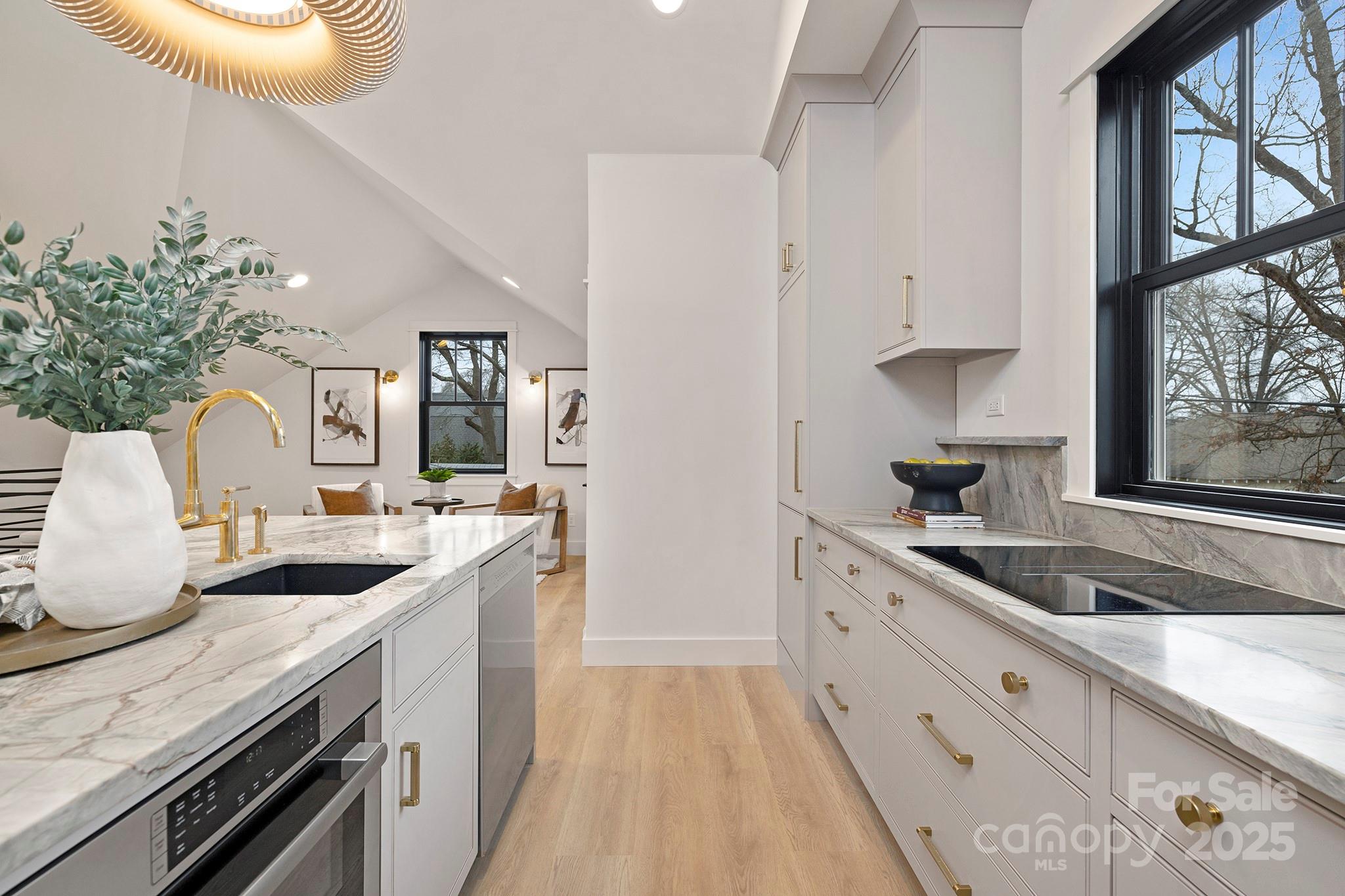 2000 Winter Street Charlotte, NC 28205 - Photo 31 of 40 a kitchen with granite countertop a sink stove and cabinets