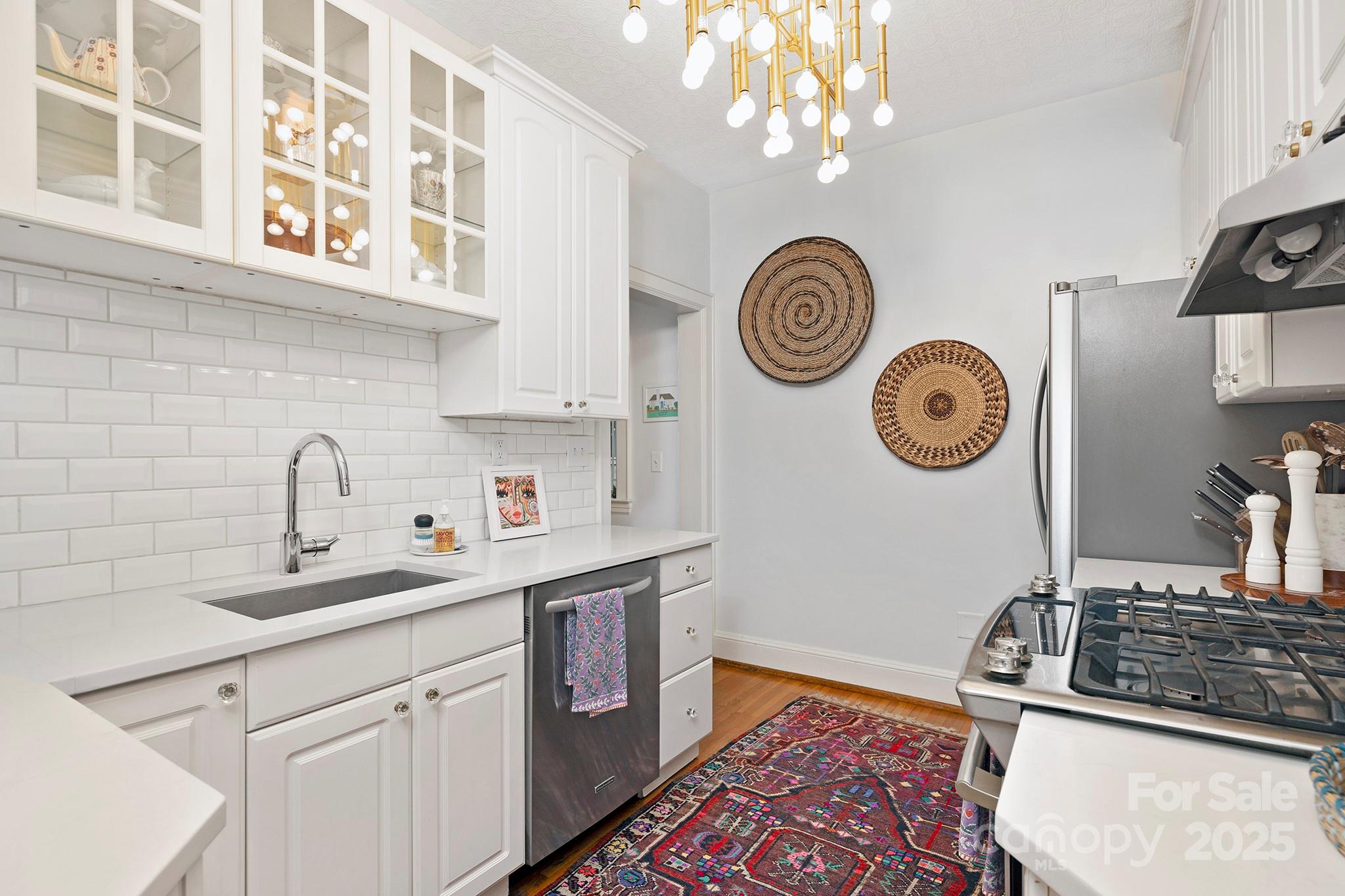 2000 Winter Street Charlotte, NC 28205 - Photo 9 of 40 a kitchen with kitchen island wooden cabinets and a stove