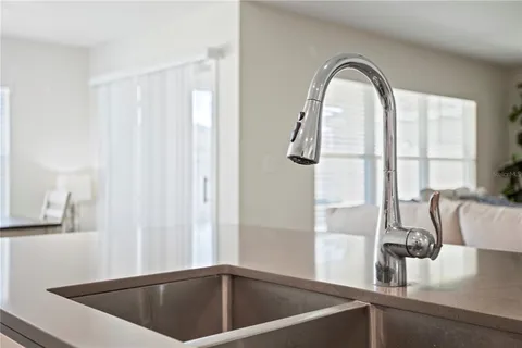 a view of kitchen with a sink and cabinet