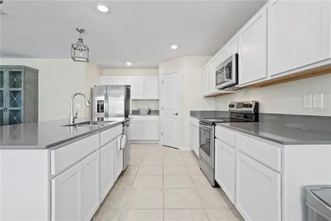 a kitchen with granite countertop a sink and cabinets