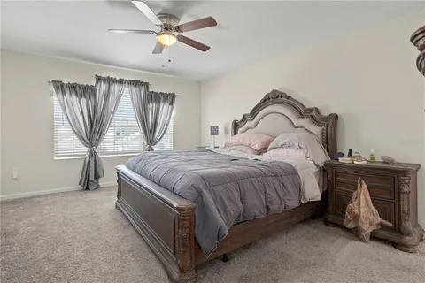 a spacious bedroom with a bed and a chandelier