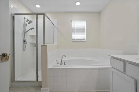 a bathroom with a bathtub and a shower