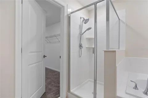a bathroom with a glass shower door and a sink