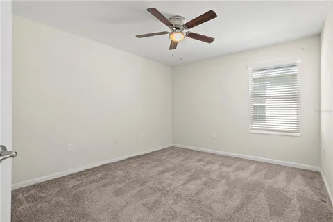 an empty room with a ceiling fan