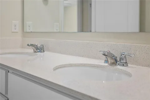 an empty room with closet and a chandelier fan