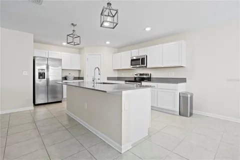 a kitchen with stainless steel appliances a refrigerator sink and microwave