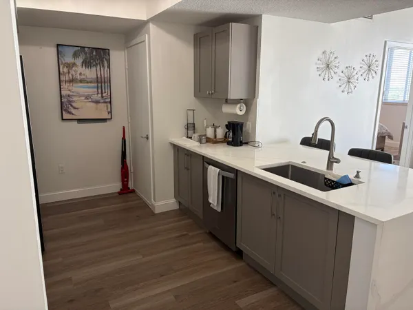 a kitchen with stainless steel appliances a sink and a refrigerator