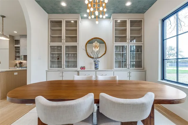 a large pool with table and chairs in it