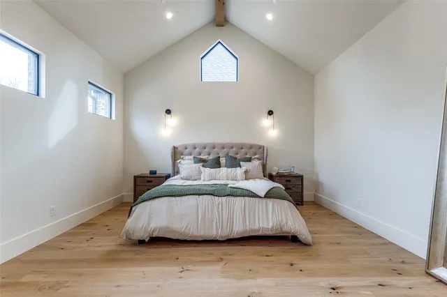 a bedroom with a bed and wooden floor