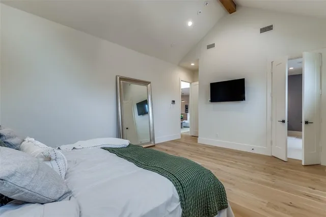 a bedroom with a bed and a flat screen tv