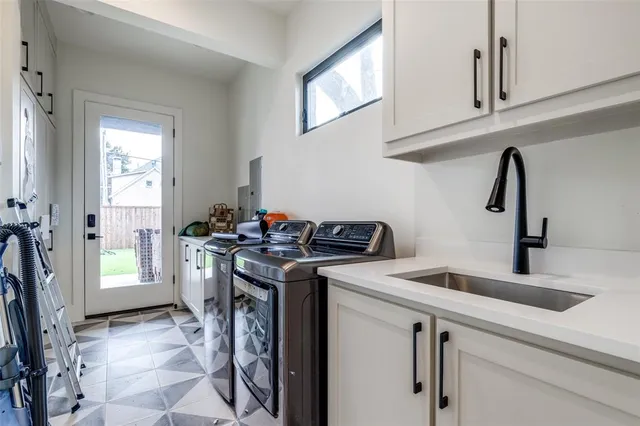 a utility room with sink dryer and washer
