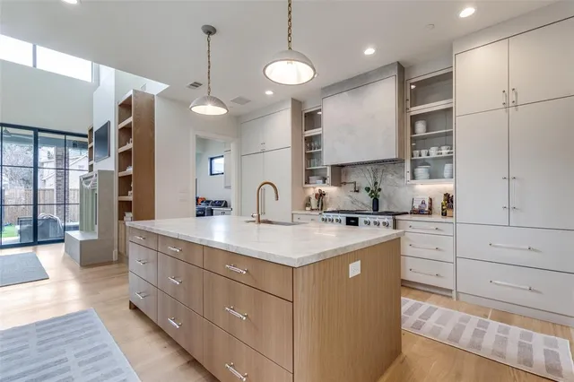 a kitchen with a sink stove and cabinets