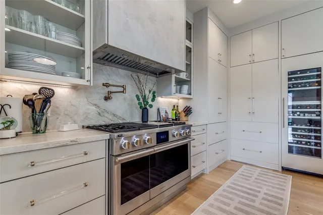 a kitchen with stainless steel appliances granite countertop a stove and cabinets