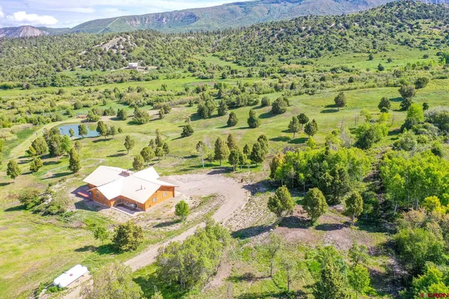an aerial view of residential houses with outdoor space