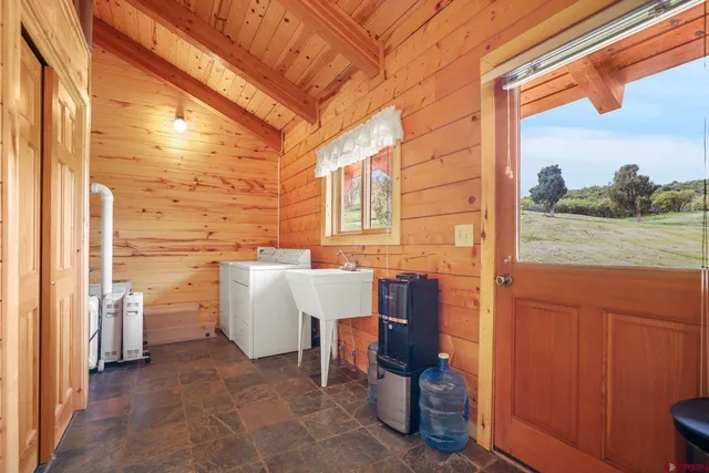 a view of a balcony with furniture and a yard