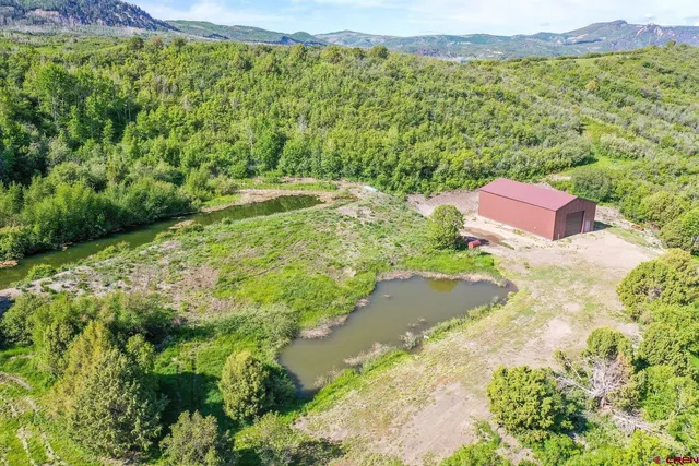 an aerial view of residential houses with outdoor space
