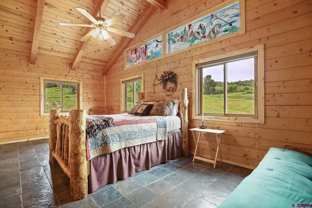 a bed sitting in a bedroom next to a window