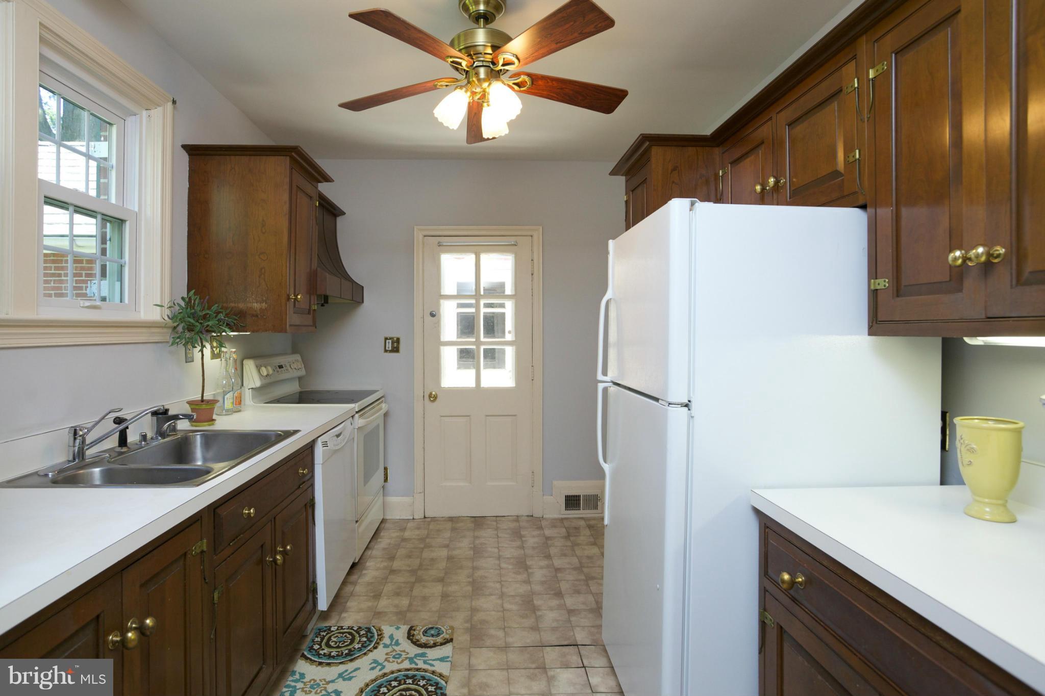 8 Aintree Road Towson, MD 21286 - Photo 13 of 27 a kitchen with a sink a refrigerator and cabinets