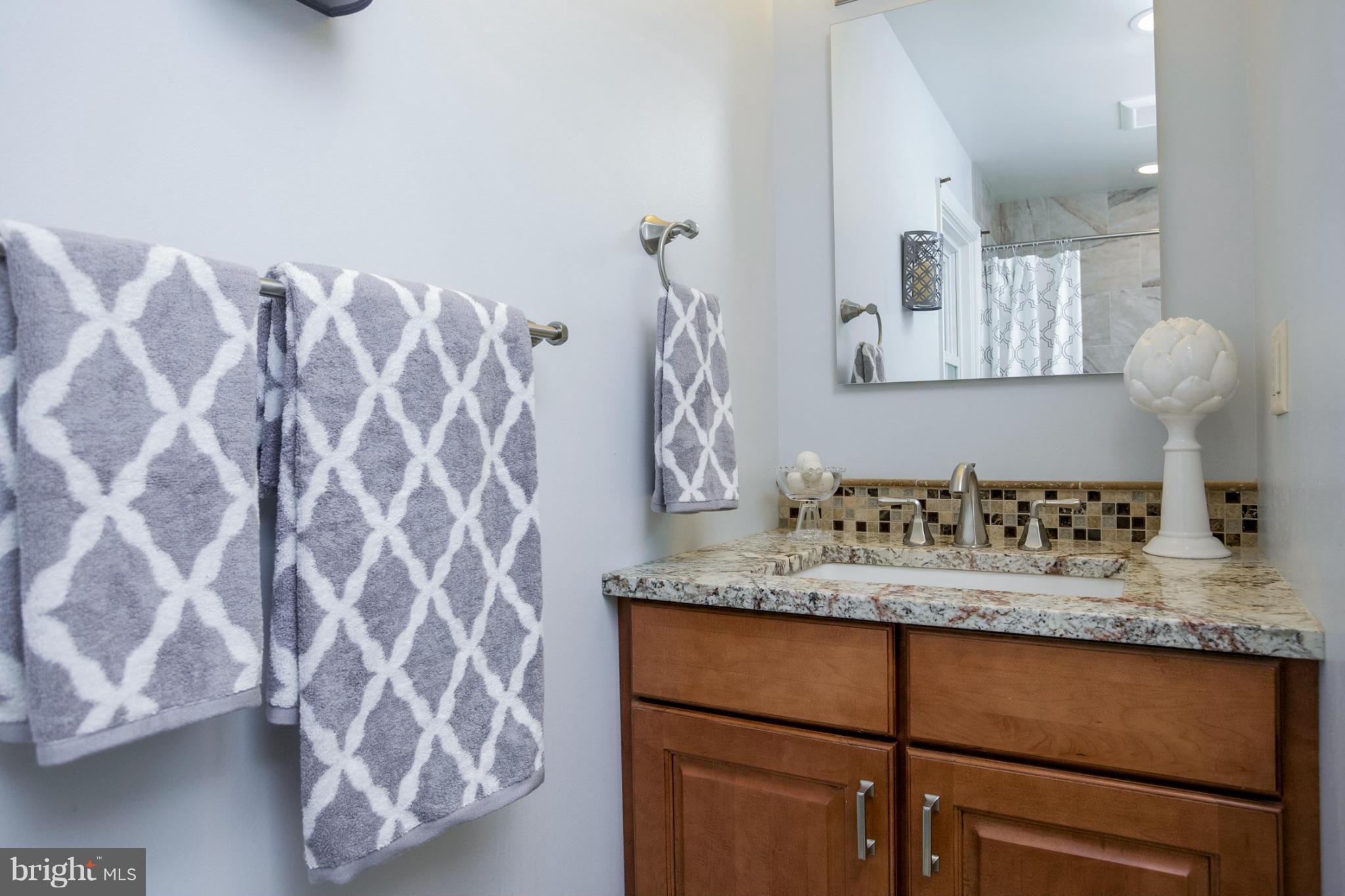 8 Aintree Road Towson, MD 21286 - Photo 22 of 27 a bathroom with a granite countertop sink and a mirror