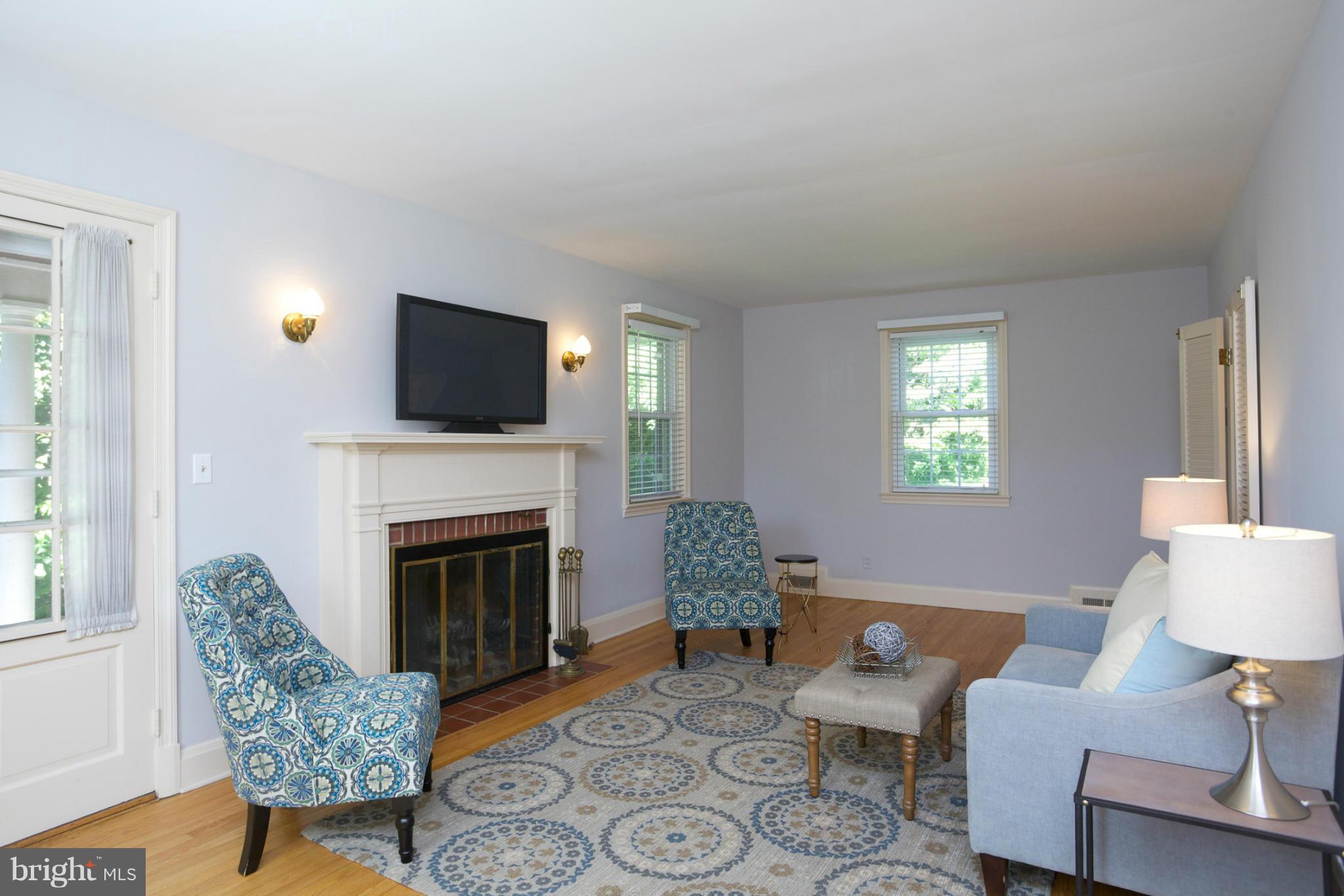 8 Aintree Road Towson, MD 21286 - Photo 8 of 27 a living room with furniture a fireplace and a flat screen tv