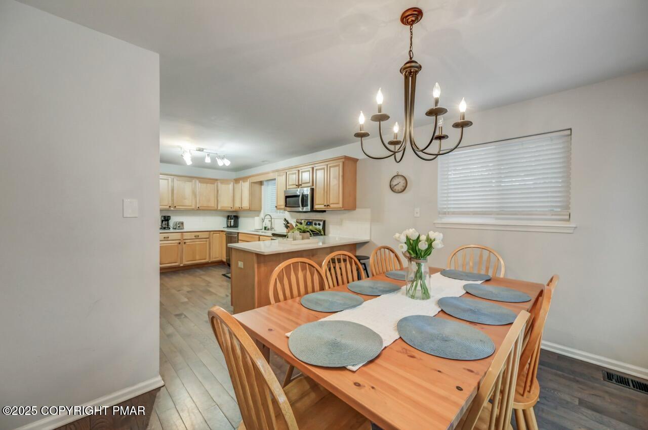 12 Hickory Road Lake Harmony, PA 18624 - Photo 17 of 86 a view of a dining room with furniture wooden floor and chandelier