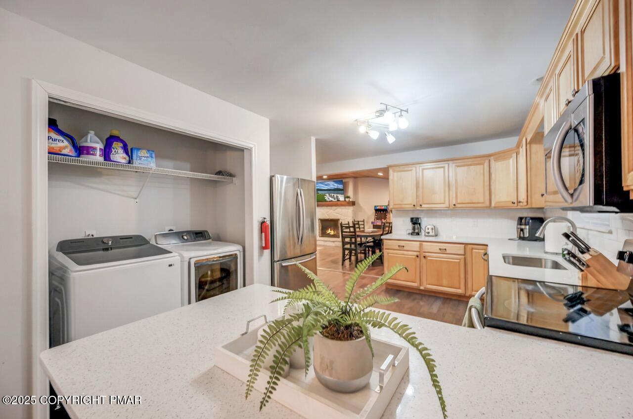 12 Hickory Road Lake Harmony, PA 18624 - Photo 22 of 86 a kitchen with stainless steel appliances granite countertop a sink dishwasher stove refrigerator and couches with wooden floor