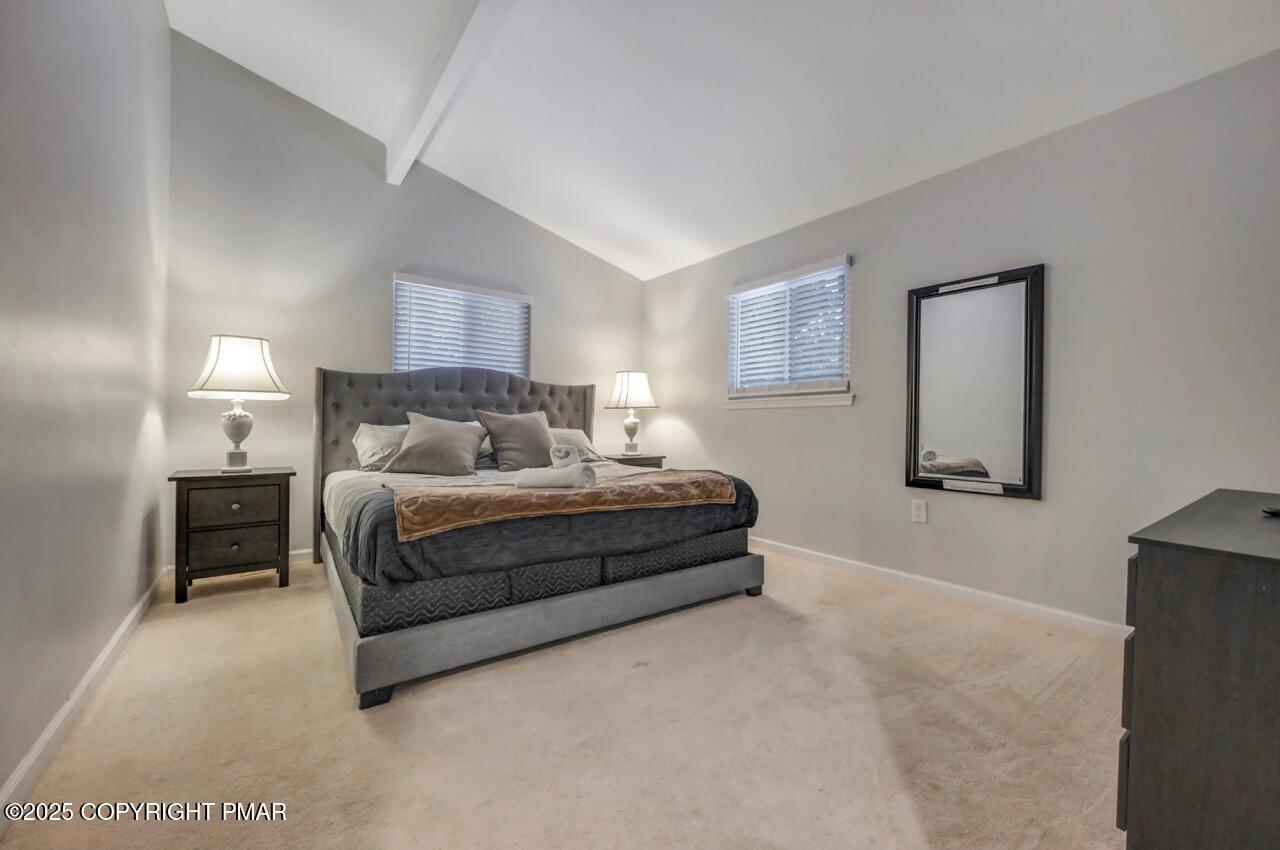 12 Hickory Road Lake Harmony, PA 18624 - Photo 44 of 86 a spacious bedroom with a bed and a lamp