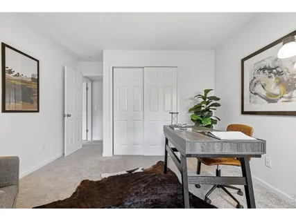 a workspace room with furniture and wooden floor