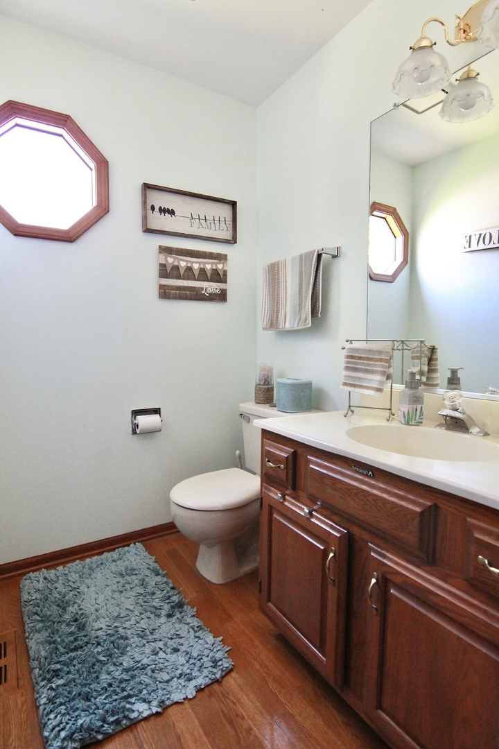 2457 Barkdoll Road Naperville, IL 60565 - Photo 11 of 27 a bathroom with a sink a toilet and mirror