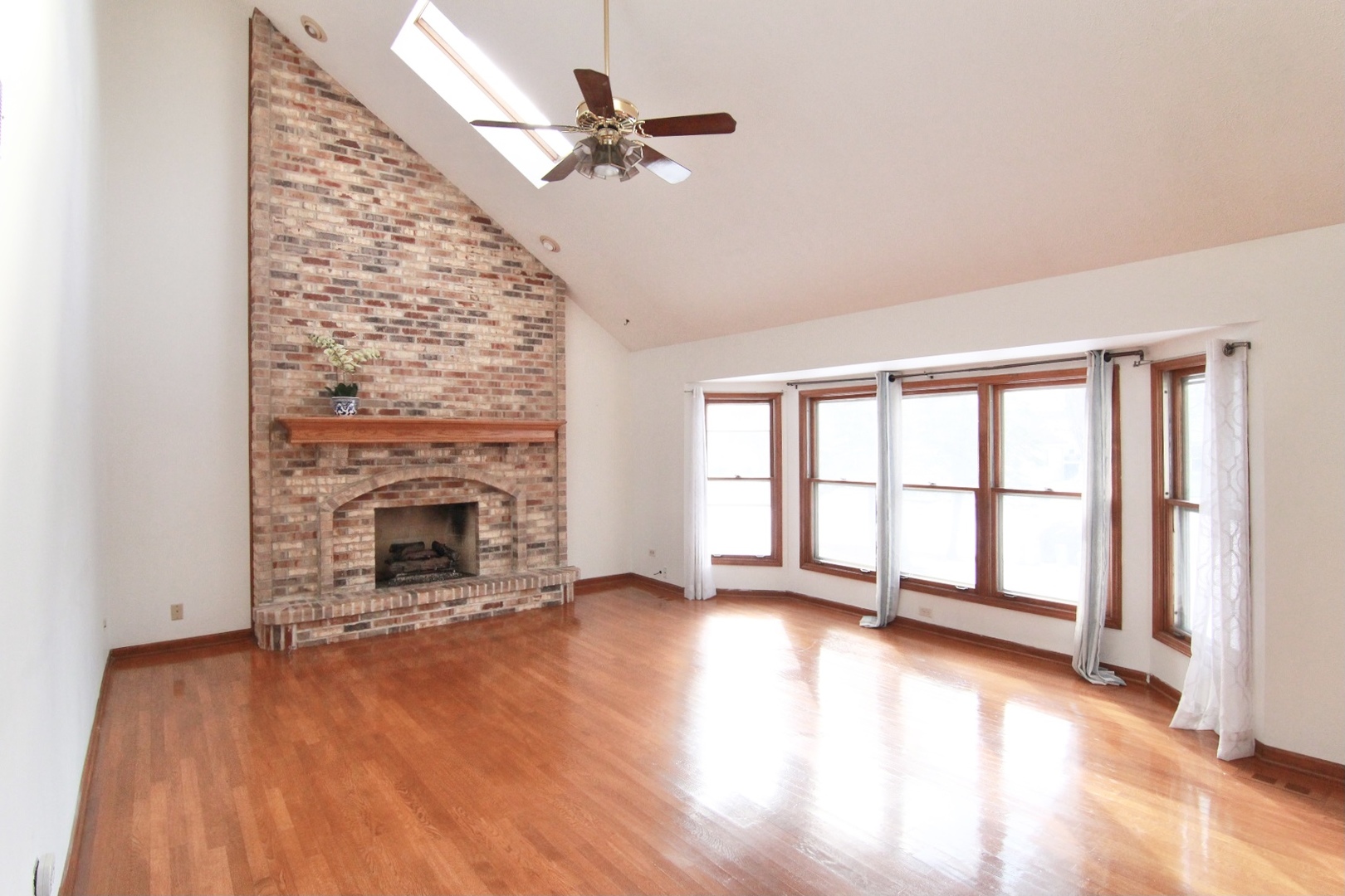 2457 Barkdoll Road Naperville, IL 60565 - Photo 7 of 27 a view of an empty room with a fireplace and a window