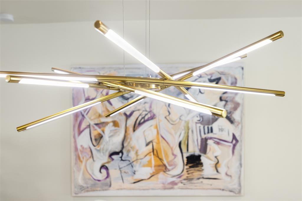 3922 Gilbert Avenue, Unit 214 Dallas, TX 75219 - Photo 6 of 27 Modern chandelier featuring multiple linear lights with a brass finish