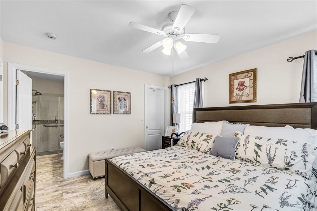 297 Christopher Drive Springfield, MA 01119 - Photo 16 of 30 a bedroom with a large bed and a chandelier