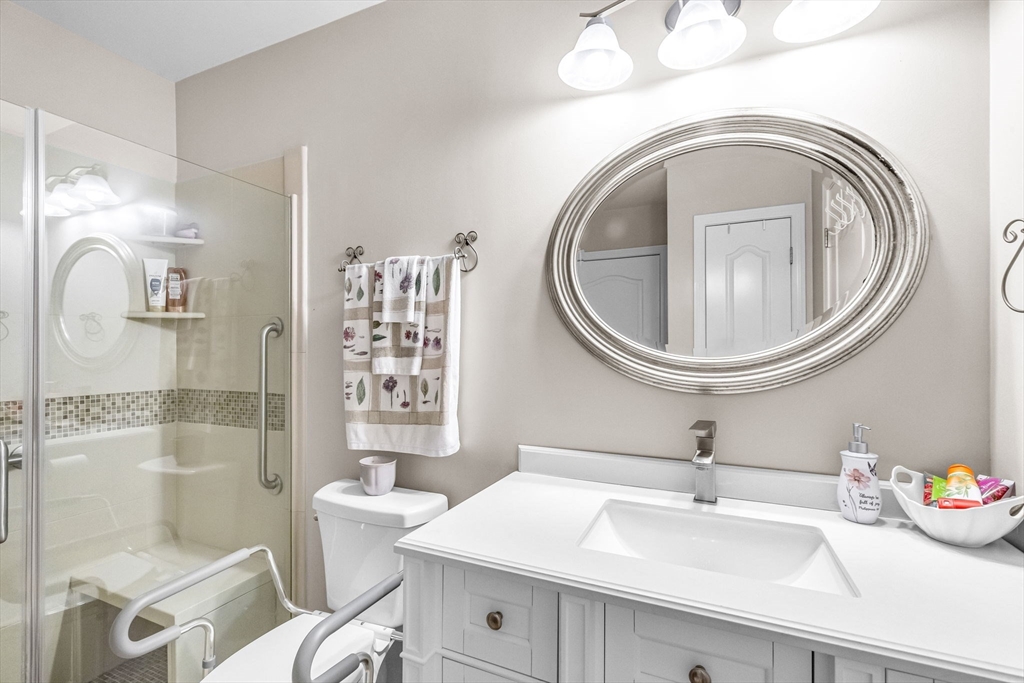 297 Christopher Drive Springfield, MA 01119 - Photo 18 of 30 a bathroom with a sink a toilet and shower