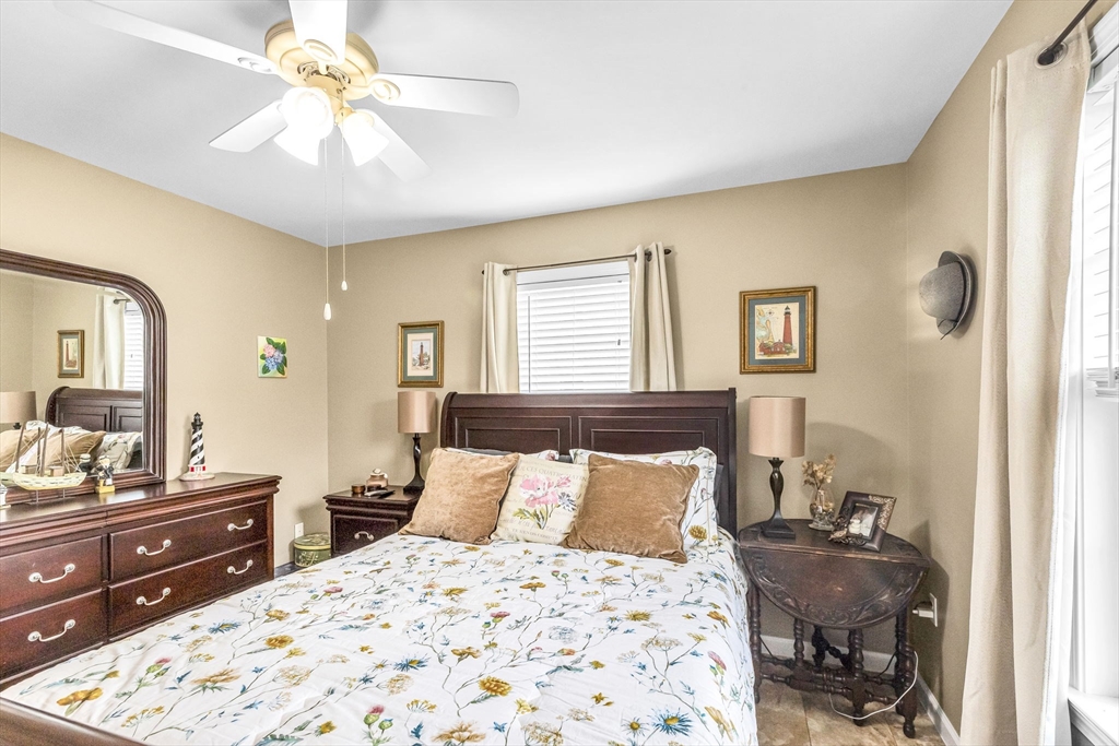 297 Christopher Drive Springfield, MA 01119 - Photo 21 of 30 a bedroom with a bed and wooden floor