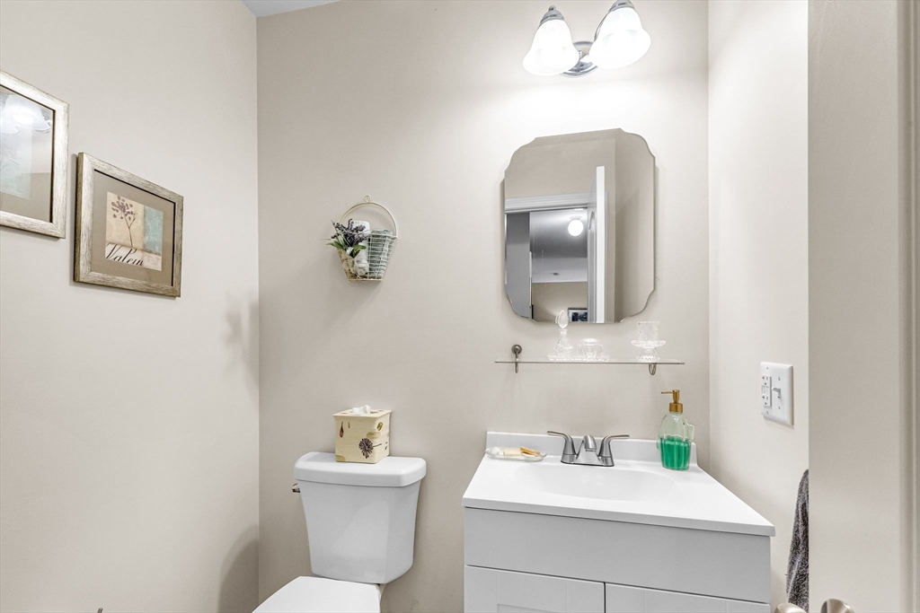 297 Christopher Drive Springfield, MA 01119 - Photo 22 of 30 a bathroom with a sink mirror and toilet