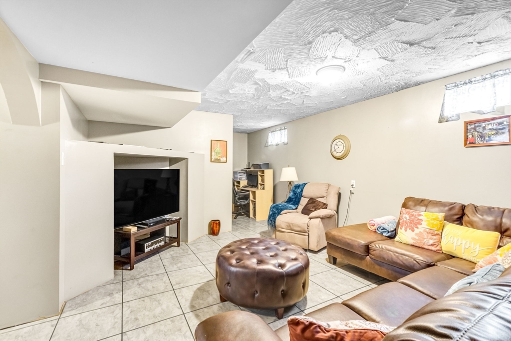 297 Christopher Drive Springfield, MA 01119 - Photo 24 of 30 a living room with furniture and a flat screen tv