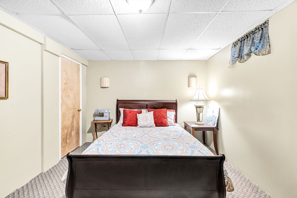 297 Christopher Drive Springfield, MA 01119 - Photo 27 of 30 a bedroom with a bed and a table in it