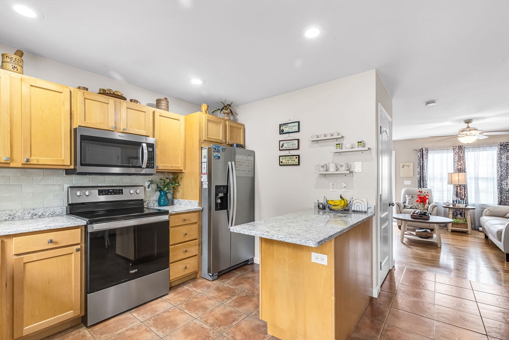297 Christopher Drive Springfield, MA 01119 - Photo 10 of 30 a kitchen with stainless steel appliances granite countertop a sink stove and refrigerator