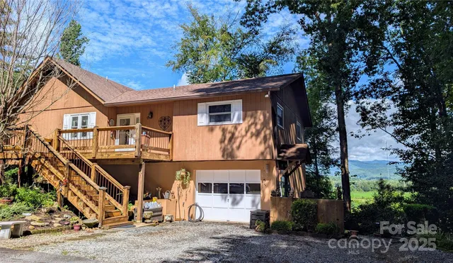 a view of a house with a yard and garage