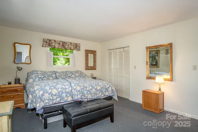 a bed sitting in a bedroom next to a window