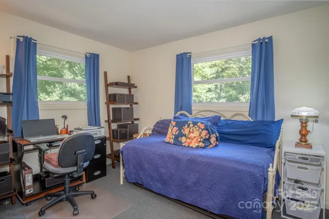 a bedroom with furniture and a window