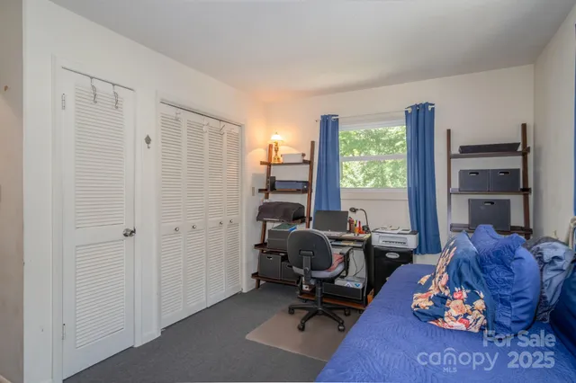 a view of a livingroom with workspace and a window